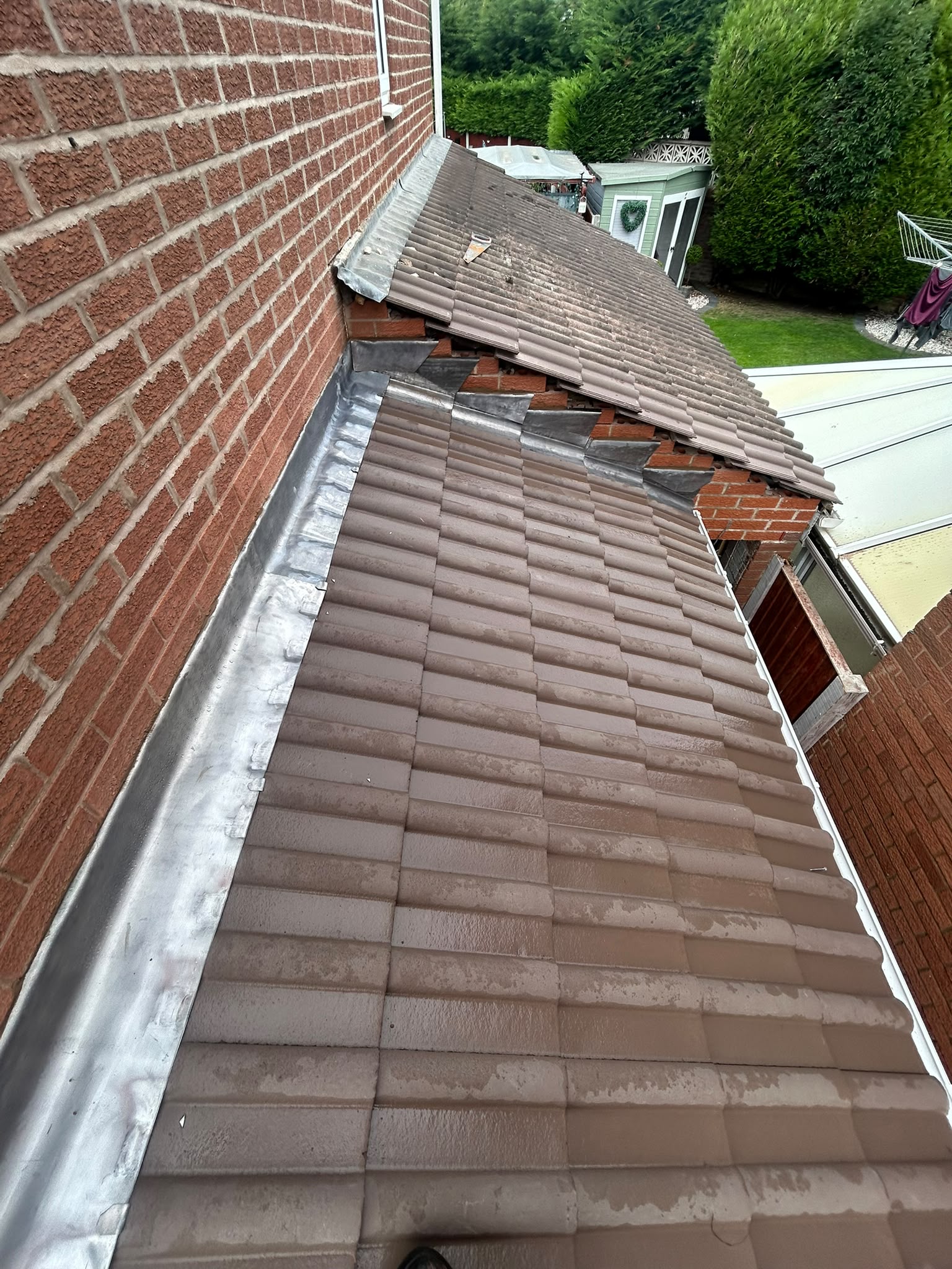 Apron and stepped lead flashing at a tiled roof abutment