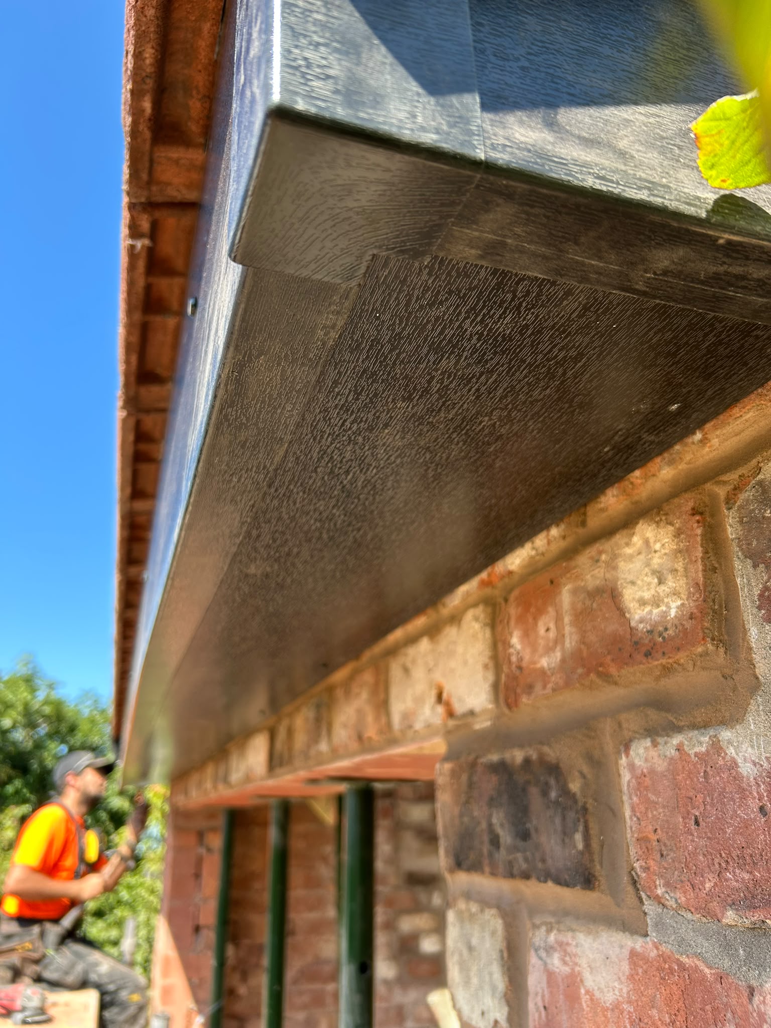 Dark wood-effect fascia and soffit boards at the eaves